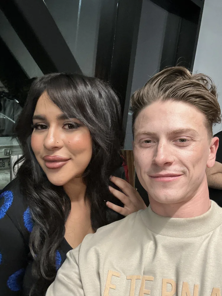 Benjamin Wills backstage with a member of the creative team after a fashion show.