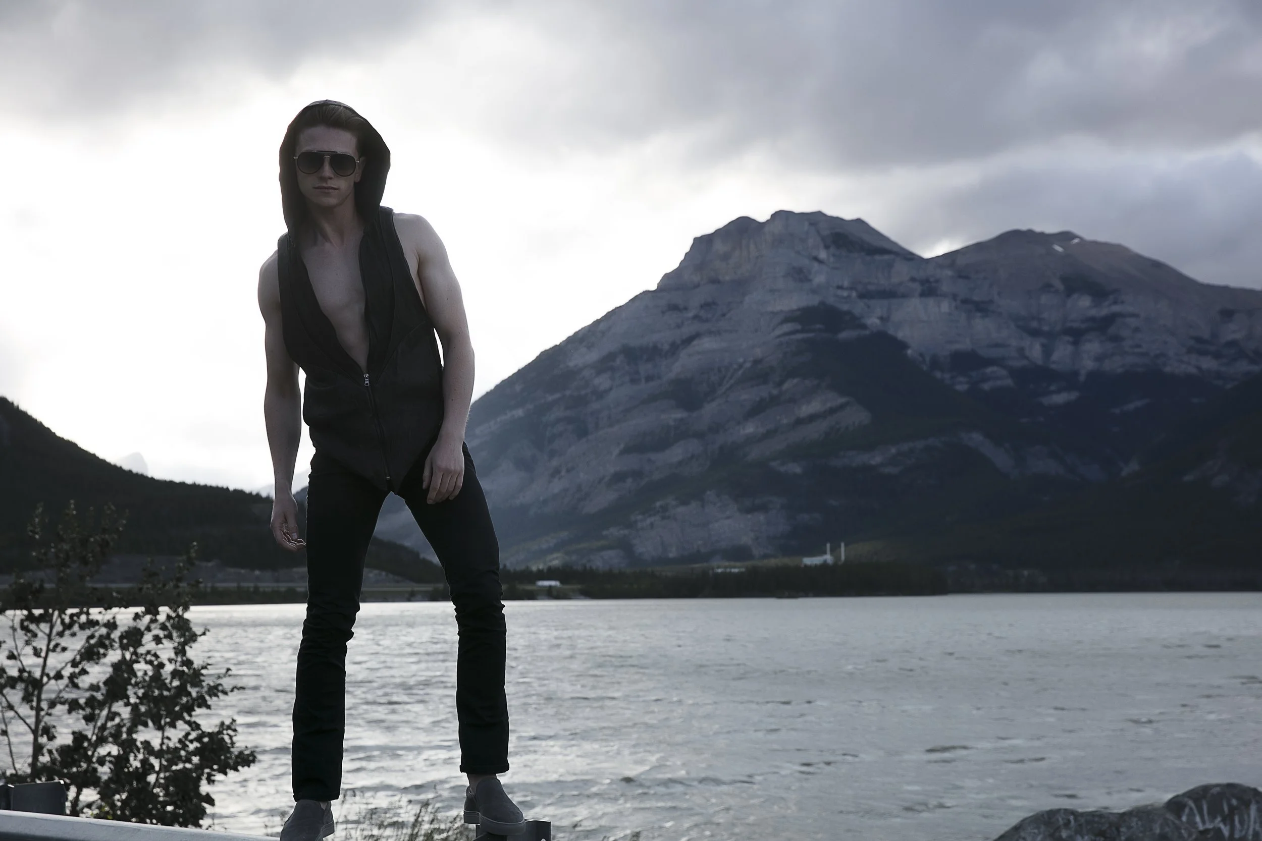 Benjamin Wills in a mountain editorial portrait beside the water.